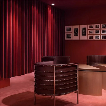 a room with red curtains and a table and chairs