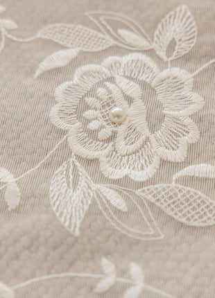 a close up of a flower on a bed sheet