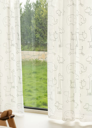 a teddy bear sitting in front of a window