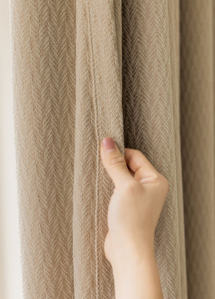 a person is holding a curtain with their hand