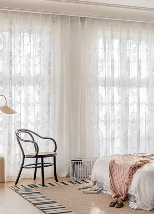 a bedroom with a bed, a chair and a window