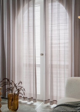 a living room with a white couch and a chair
