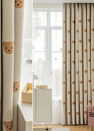 a child's bedroom with a teddy bear curtain