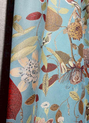 a close up of a curtain with flowers on it