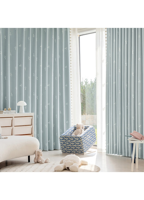 a baby's room with a blue and white theme