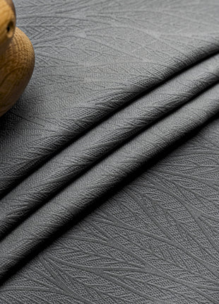 a close up of a black leather material with a wooden handle