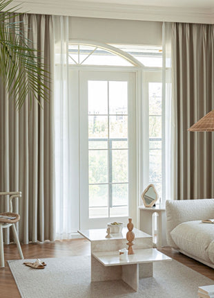 a living room filled with furniture and a large window