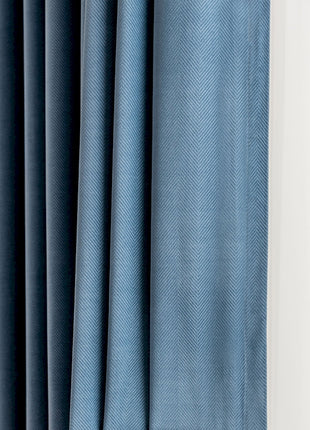 a close up of a curtain with a blue background
