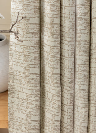 a close up of a curtain with a flower in a vase