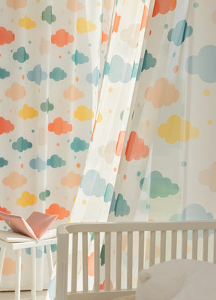 a baby's room with a crib and curtains