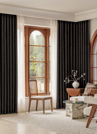 a living room filled with furniture and a large window