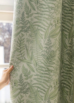 a person is holding a curtain in front of a window