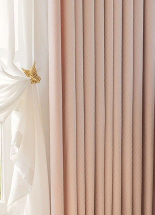 a window with a white curtain and a white dresser