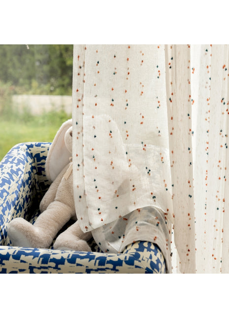 a teddy bear is sitting in a blue chair