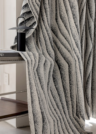 a room with a table, chair, and a curtain