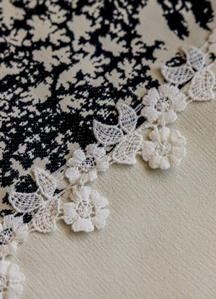 a close up of a piece of cloth with crocheted flowers on it