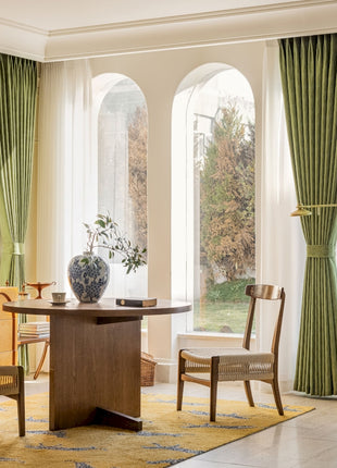 a living room with a table and chairs