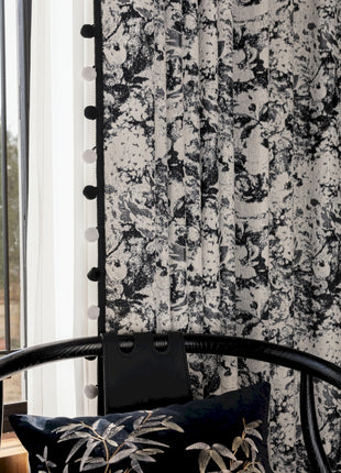 a black and white wallpapered room with a chair next to a window