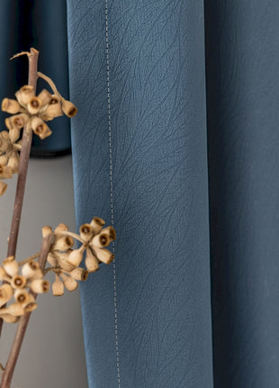 a branch of a plant in front of a mirror