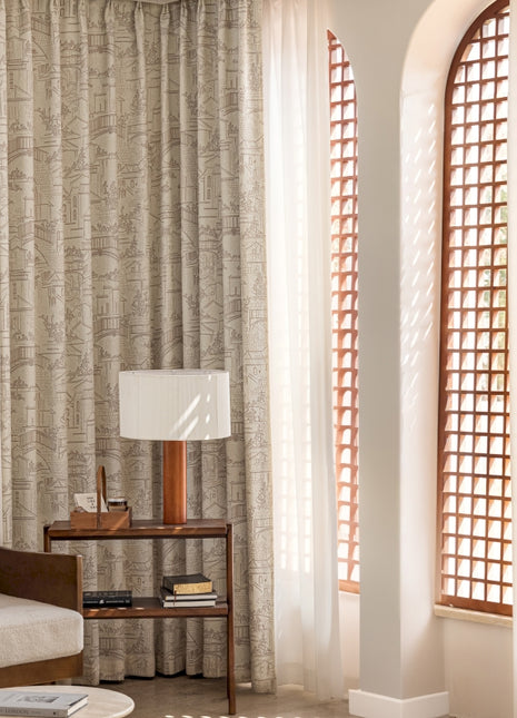 a living room filled with furniture and a tall window