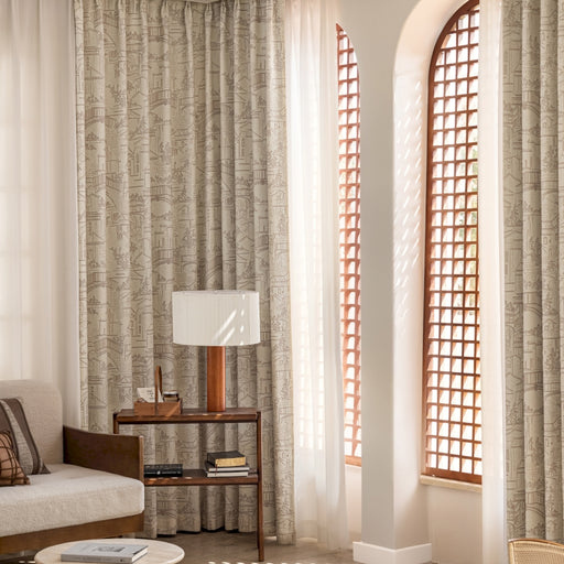 a living room filled with furniture and a tall window