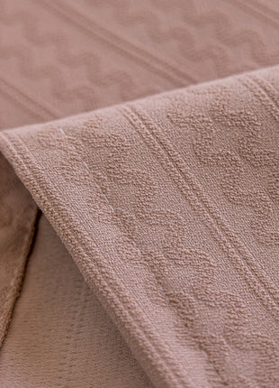 a close up of a blanket on a bed