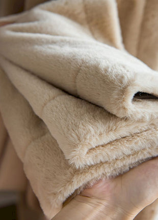 a person holding a blanket in their hands