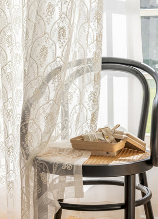 a chair sitting next to a window with a box on top of it