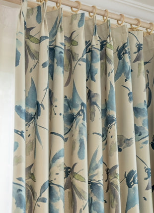 a close up of a curtain with blue flowers on it