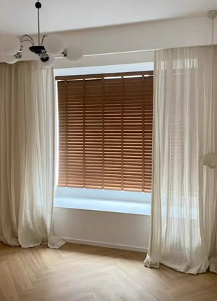 an empty room with a window and a curtain