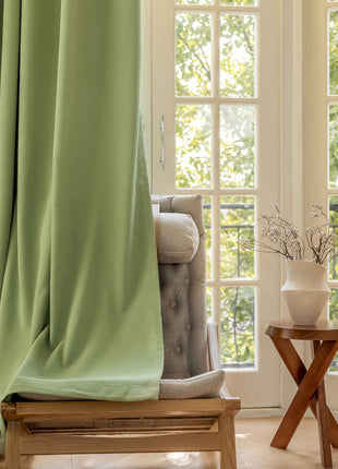 a living room with a chair and a window
