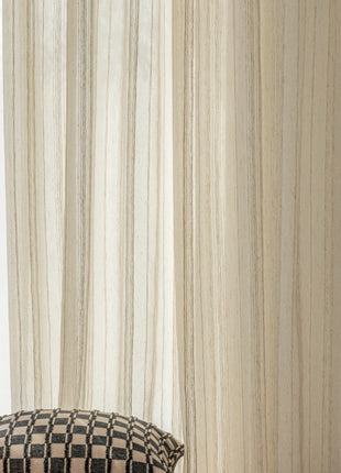 a black and white checkered pillow sitting next to a window