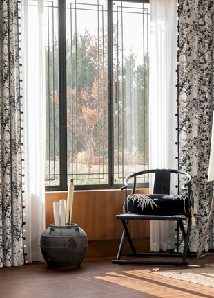 a living room with a chair and a large window
