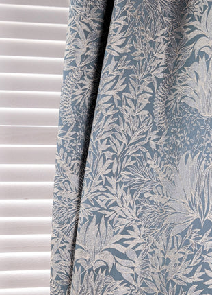 a curtain with a blue and white floral pattern