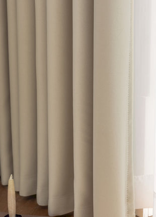 a close up of a curtain with a pen on it