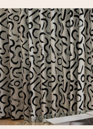 a curtain with a black and white pattern on it
