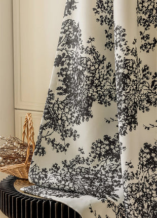 a close up of a curtain with a black and white pattern
