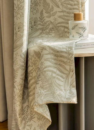 a table with a book and a vase on top of it