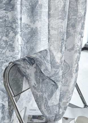 a chair sitting in front of a window next to a curtain