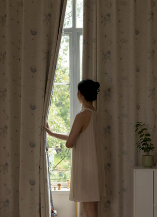 a woman standing in front of a window