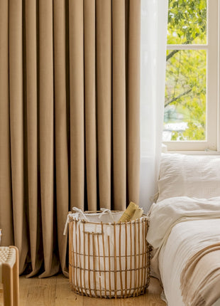 a room with a bed, a basket and a window