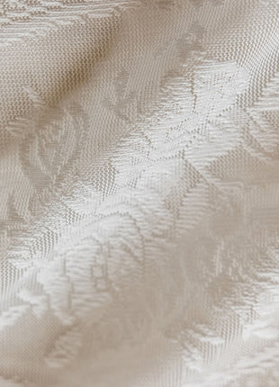 a close up of a white fabric with a pattern