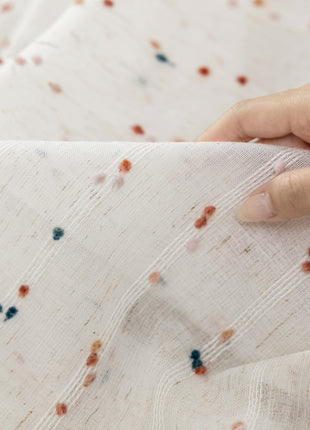 a person is holding a piece of fabric