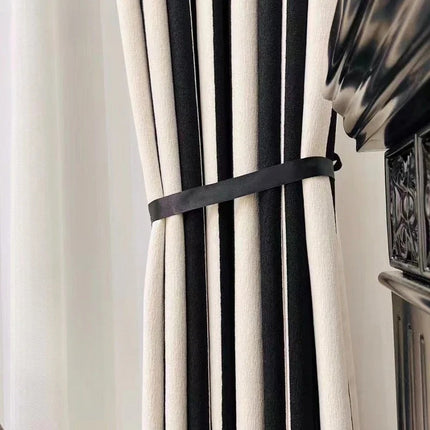 a black and white curtain with a black ribbon