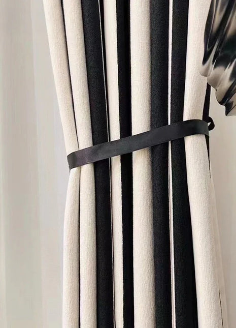 a black and white curtain with a black ribbon