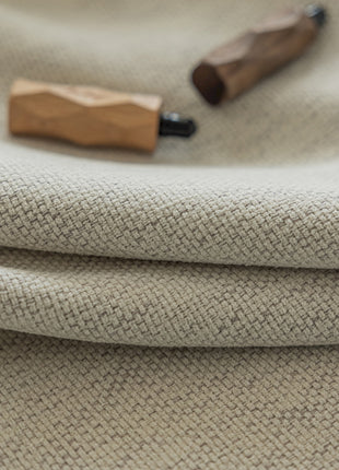 a close up of a cloth with a wooden object on it