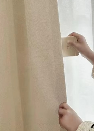 a child is holding a curtain with a light - colored curtain
