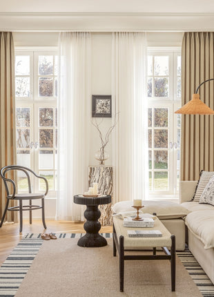 a living room filled with furniture and a large window