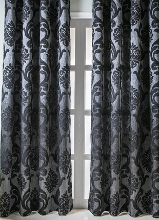 a living room with a chair and a window