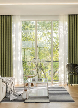 a living room filled with furniture and a large window
